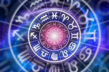 Zodiac signs inside of horoscope circle on universe background