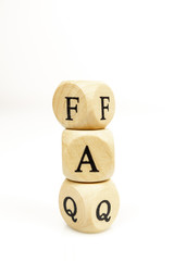 The letters FAQ in wooden cubes on white background