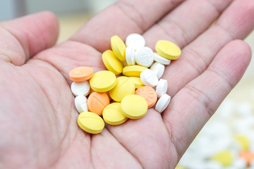 Colorful pills and drugs in close up. Assorted pills and drugs in medicine. Opioid and prescription medication addiction epidemic. Drugs of various kinds.