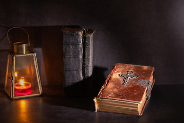 old bible on a table with candle light