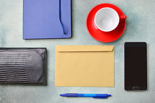Message concept. Empty postal envelope blank and other business acccessories. Flat lay background.  Copy space.