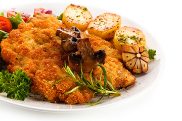 Fried pork chop with potatoes on white background