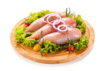 Fresh raw chicken fillet on wooden cutting board on white background