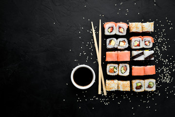 Big Set sushi with soy sauce and wasabi. Free space for your text. Top view. On a stone background.