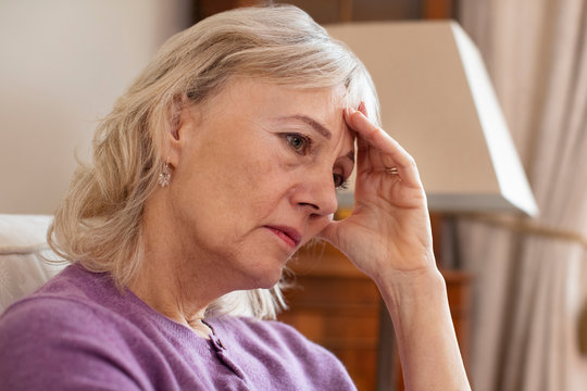 Side View Of Depressed Senior Woman At Home