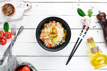 Risotto with vegetables in a plate. Rice. On the old background. Top view. Free space for your text.