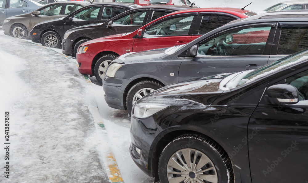 Sticker cars in the parking lot in the winter