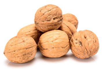 Six whole walnuts, close up macro, isolated on a white background.