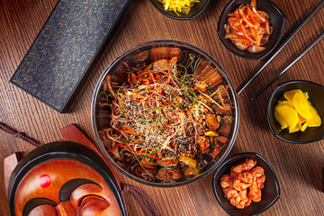Asian food. korean cuisine. Top view spicy korean noodles with kimchi set and seafood with vegetables. Traditional korean cuisine set. Picture for recipe. Copy space for text logo or brand.