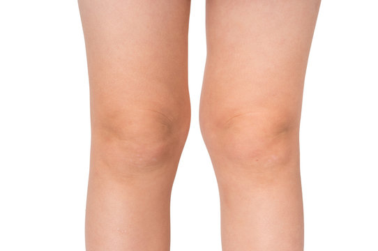 Knees of little baby isolated on white