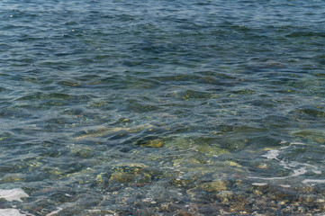 Clear water and colorful pebbles on the sea