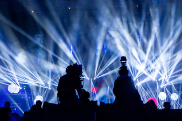 A group of cameramen working during the concert.