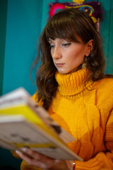 young woman reading book at cold winter night