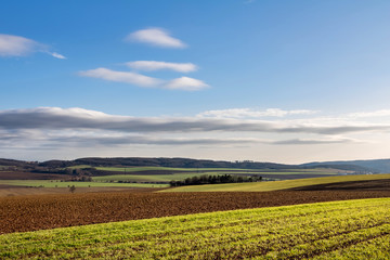 Amazing fall countryside with fields, forests and blue sky
