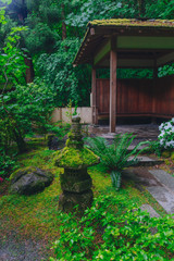 Pagoda decoration and house among trees at Portland Japanese Garden, Portland, USA