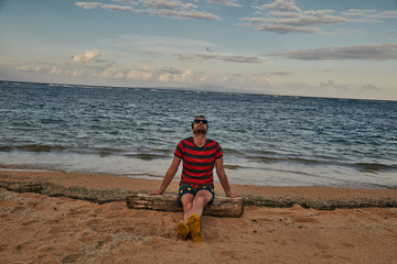 Man enjoying on a deserted tropical beach.