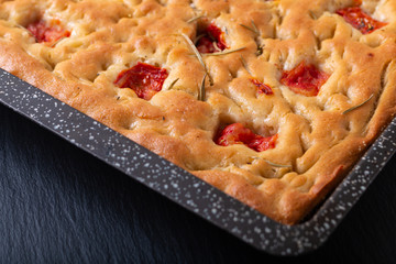 Food concept homemade organic focaccia in iron pan with copy space