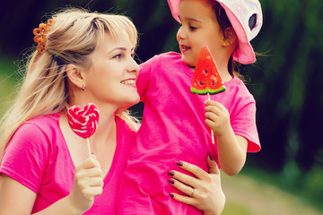 Mother and daughter with lollipops