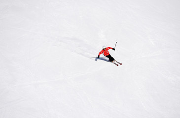 Skier skiing downhill during sunny day in high mountains. Italy, Europe.