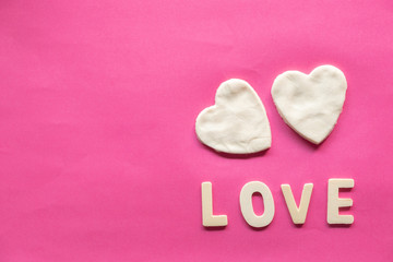 shape of heart, White heart and word LOVE on pink background, Love icon, valentine's day, relationships concept with copy space