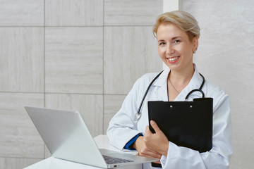 Female doctor looking at camera and working.