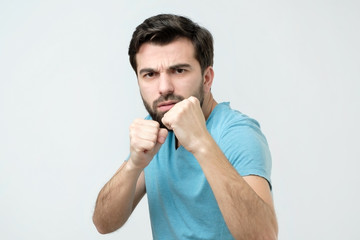 Handsome young hispanic man in fighting position