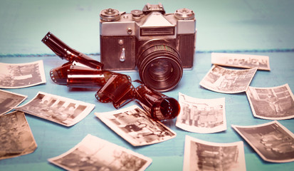 Vintage camera with photos on blue background