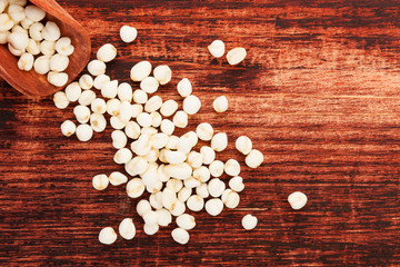 Nelumbo nucifera or lotus seeds on wooden background.