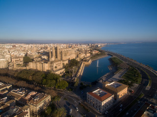 Aerial drone view Majorca cityscape, road along the coast of mediterranean sea and famous Cathedral of Palma de Mallorca or Le Seu. © VaLife
