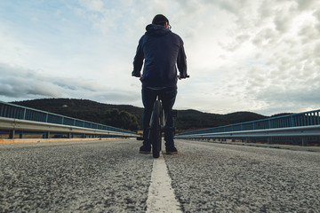 BMX rider with his bmx bike on the street. Guy riding in bmx