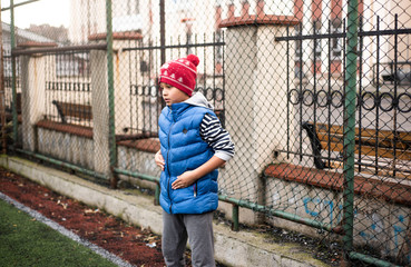 Cool african american football player boy playing football with his brother downstairs. Active mixed kids. School boys  free time. Children and sport. Brothers game. Shooting in December 2018 Istanbul