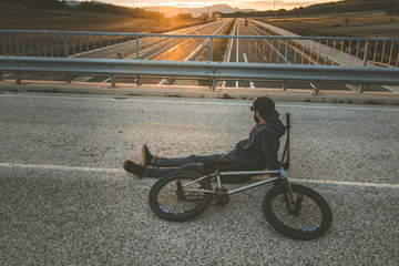 BMX rider with his bmx bike on the street. Guy riding in bmx