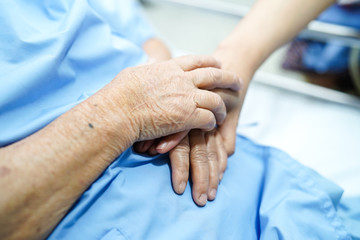 Touching hands Asian senior or elderly old lady woman patient with love, care, helping, encourage and empathy at nursing hospital ward : healthy strong medical concept 