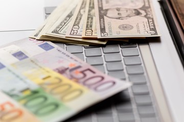 Background with american dollar and euro bills.