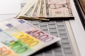 Background with american dollar and euro bills.