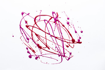 Nail polish on a white background in the form of strips and drops