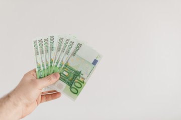 Euro bills in male hands. Euro cash background.