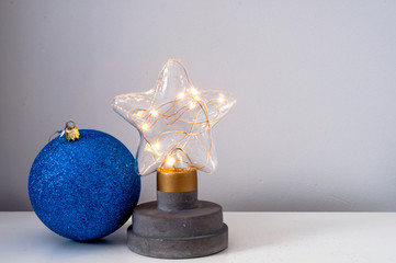 New Year's home decor, decorative lamp in the form of a star with yellow and blue balls from the side