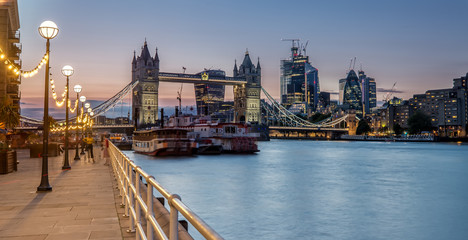 The Tower Bridge in London lights up in the Evening