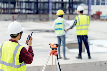 surveyor engineer with theodolite at construction site during surveying work.engineer and architect...