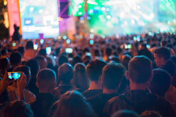crowd of people at concert or show, defocused background