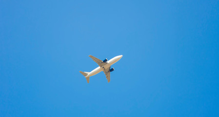 airplane flying over clear blue sky