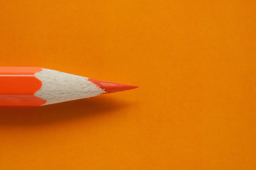 Macro photo of orange pencil on orange paper