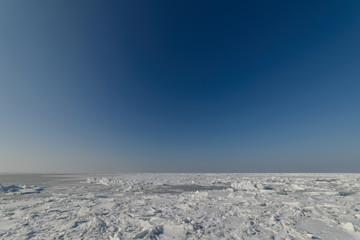 Fototapeta na wymiar Frozen sea view on sunny day.