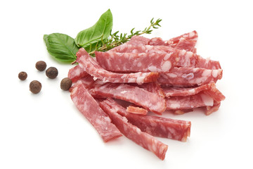 Sliced Salami with basil and pepper, isolated on a white background. Close-up