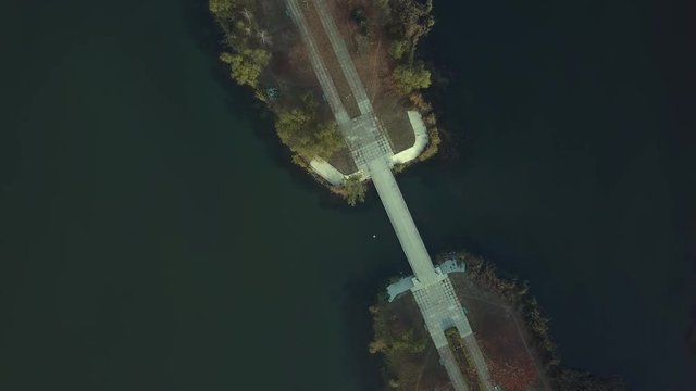 Aerial footage over Echo Park Lake, Kishinev, Moldova republic of. View of lake and smille bridge.