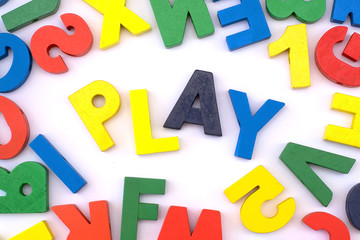 Many colorful wooden letters and word "Play" on white background