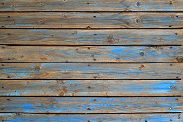 Old wooden pallet with scratched blue paint