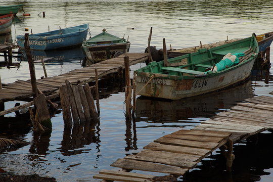 Rowing boats moored at wooden jetty docks in Matanzas province Cuba