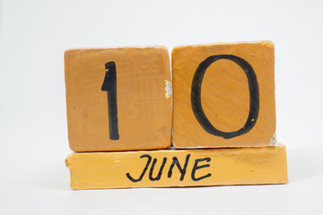 june 10th. Day 10 of month, handmade wood calendar isolated on white background. summer month, day of the year concept